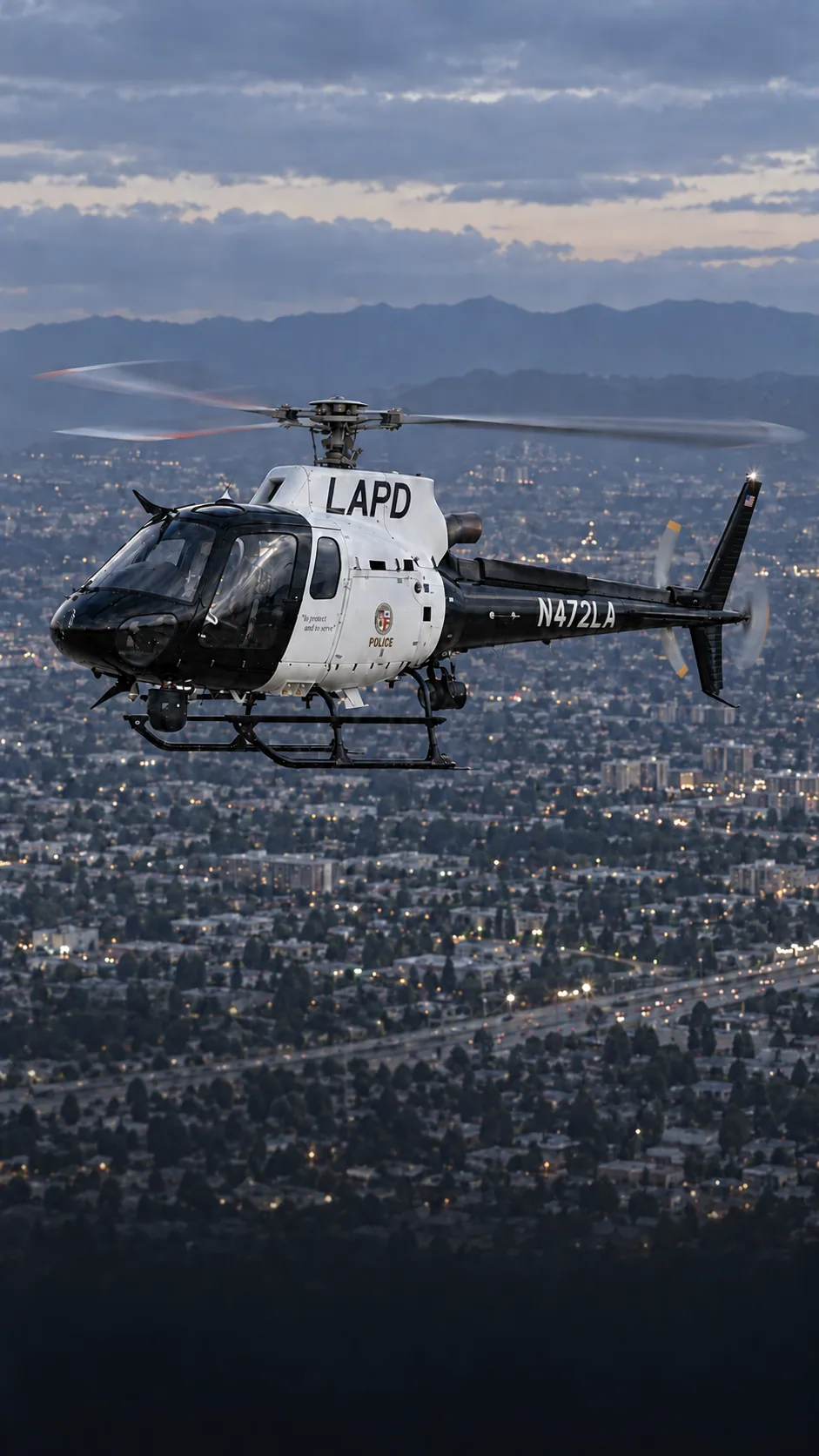 Illustration of an LAPD Air Support Division Airbus AS350 in black and white livery, registration N472LA, over Los Angeles at dusk.