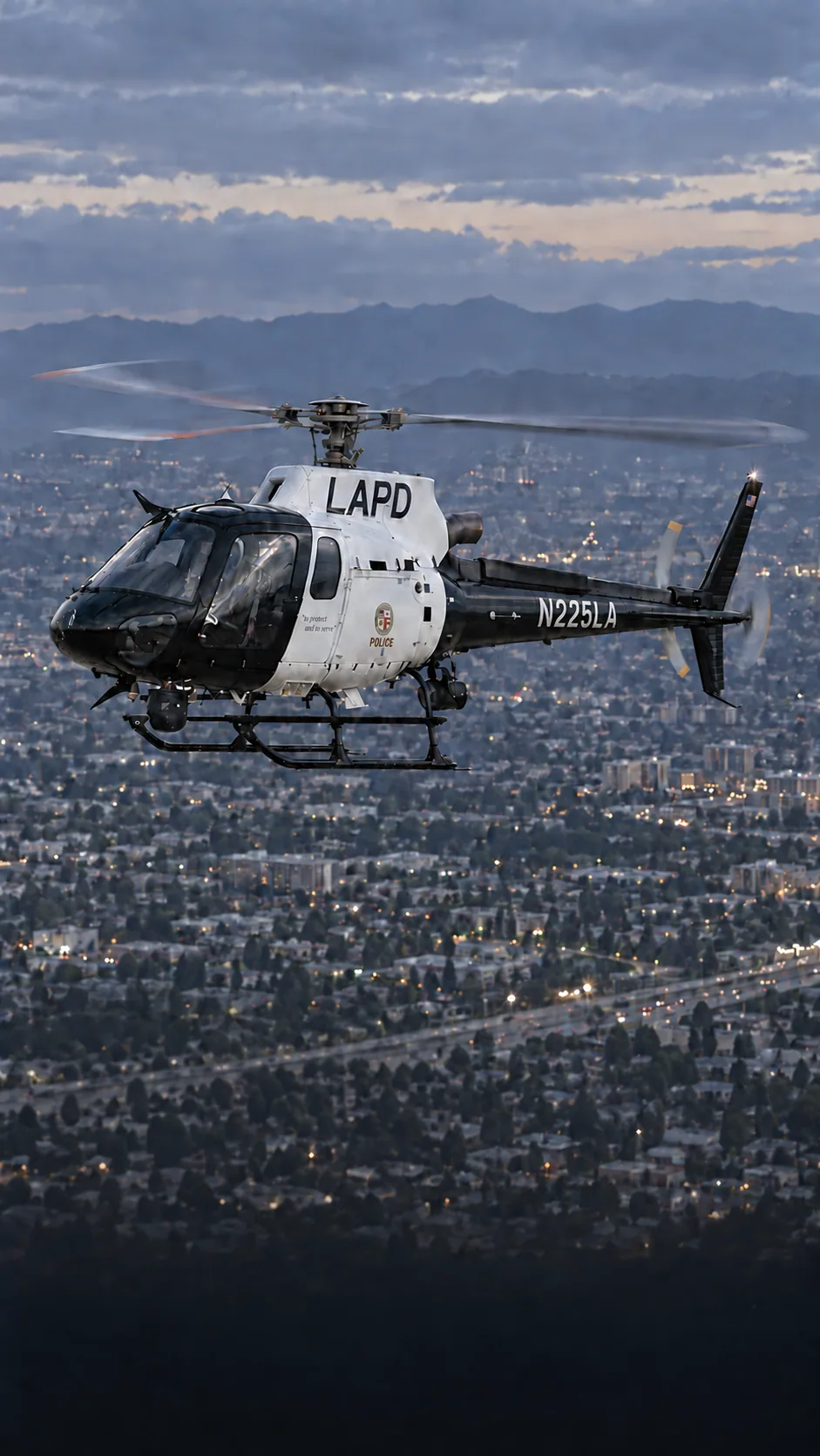 Illustration of LAPD Air Support Division Airbus AS350 N225LA in black and white livery over Los Angeles at dusk.