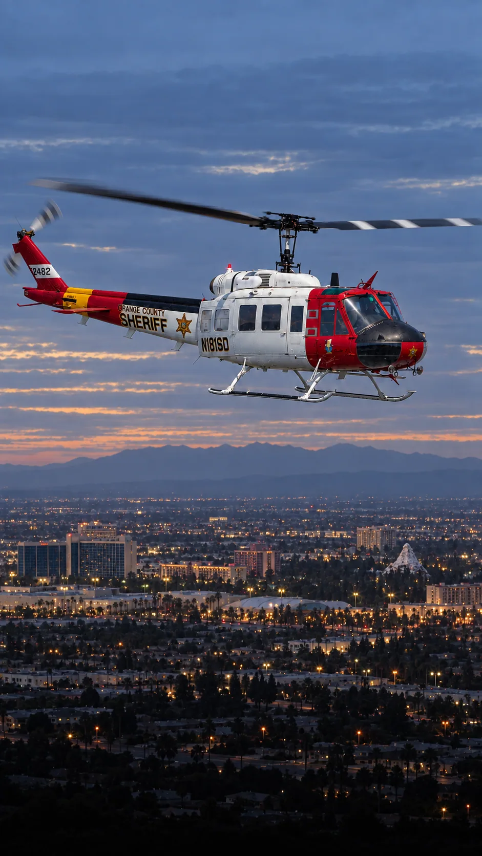 Illustration of N181SD, a Bell UH-1V of the Orange County Sheriff — over Anaheim, Orange County.