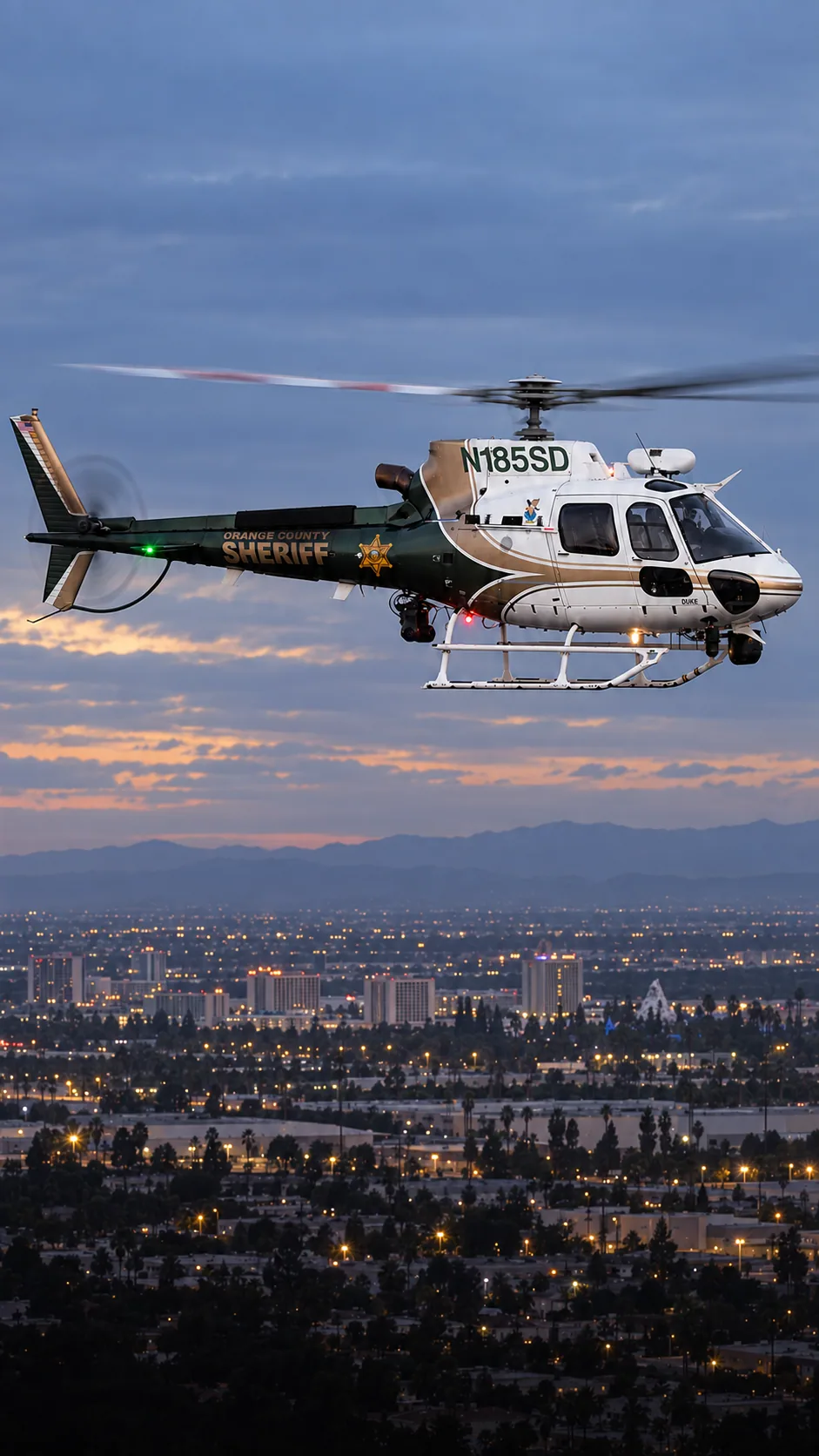 Illustration of N185SD, an Airbus AS350 of the Orange County Sheriff — orange County Sheriff DUKE — over Anaheim, Orange County.